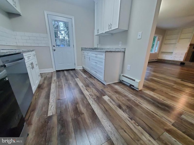 kitchen featuring light stone countertops, stainless steel dishwasher, dark wood-type flooring, a baseboard heating unit, and white cabinets