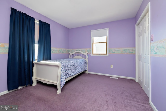 carpeted bedroom featuring a closet