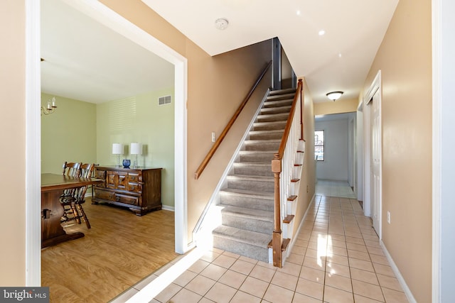 stairs with hardwood / wood-style floors