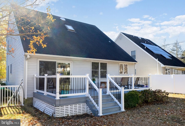 back of property featuring a deck