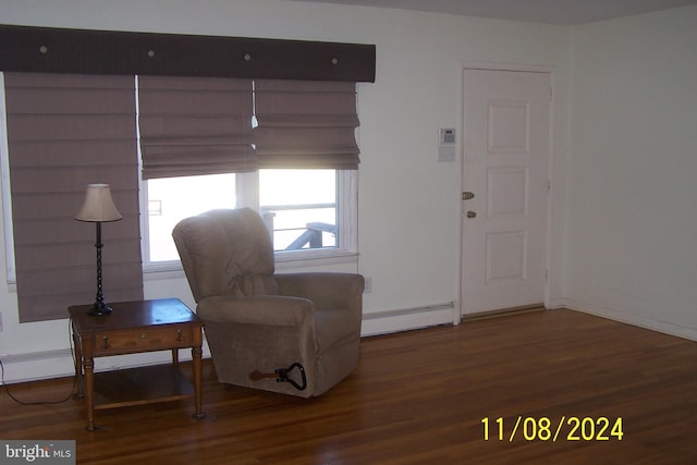 living area featuring hardwood / wood-style floors and baseboard heating