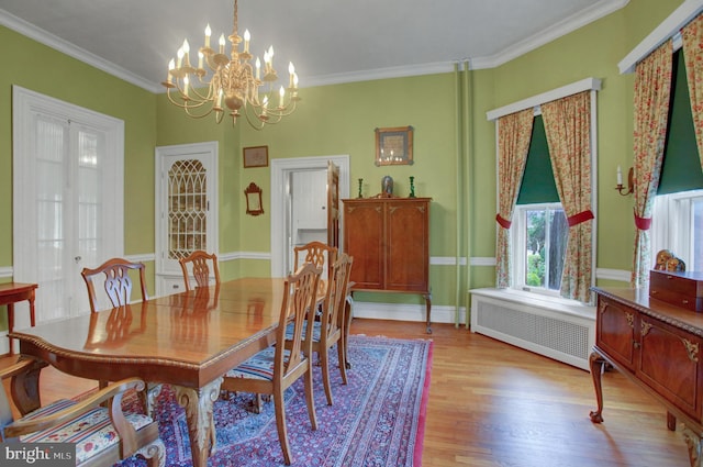 144 W Main St, Waynesboro, PA 17268 - dining space featuring radiator, a chandelier, light wood-type flooring, and ornamental molding