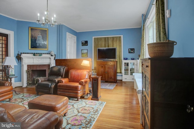144 W Main St, Waynesboro, PA 17268 - living area featuring a chandelier, light wood-style floors, a brick fireplace, and crown molding