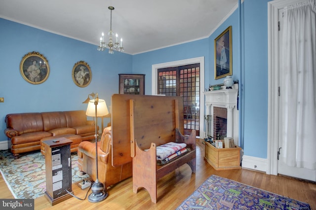 144 W Main St, Waynesboro, PA 17268 - living room with wood finished floors, a chandelier, crown molding, a fireplace, and baseboards