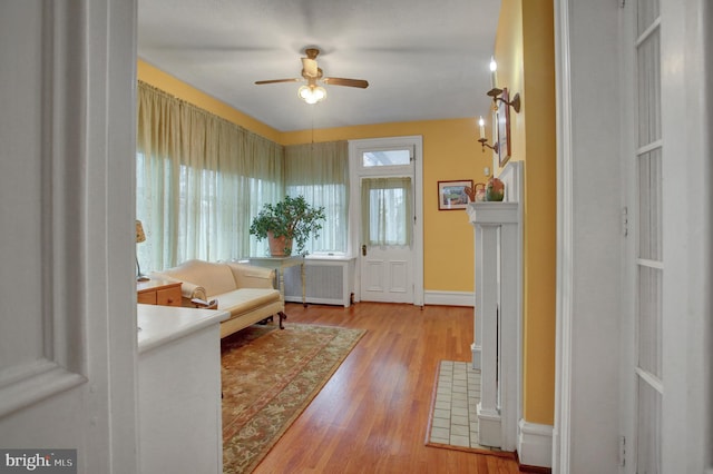 144 W Main St, Waynesboro, PA 17268 - foyer featuring a ceiling fan, light wood-type flooring, radiator heating unit, and baseboards