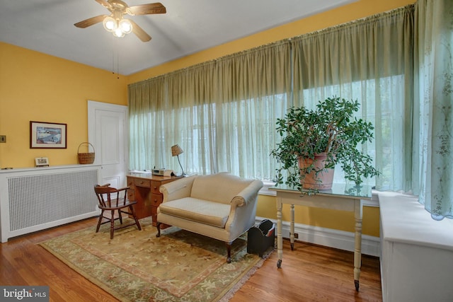 144 W Main St, Waynesboro, PA 17268 - sitting room with radiator heating unit, a ceiling fan, wood finished floors, and baseboards
