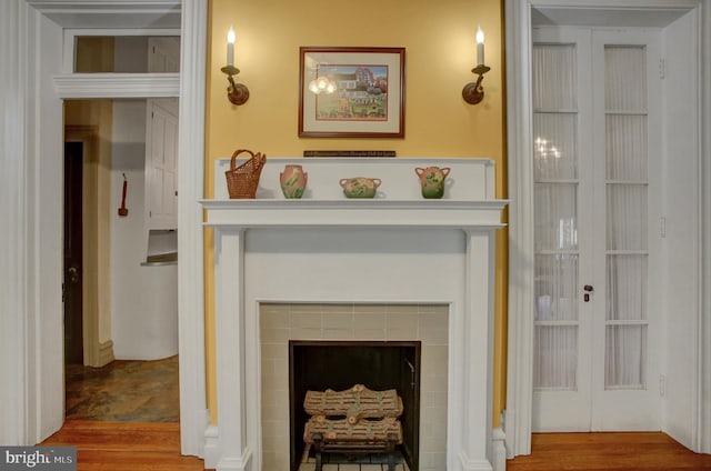 144 W Main St, Waynesboro, PA 17268 - detailed view of wood finished floors, french doors, and a tiled fireplace