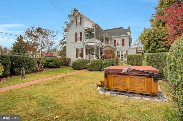 144 W Main St, Waynesboro, PA 17268 - rear view of property with a hot tub, a yard, and a chimney