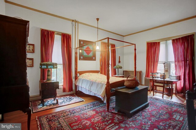 144 W Main St, Waynesboro, PA 17268 - bedroom featuring radiator heating unit, crown molding, and wood finished floors