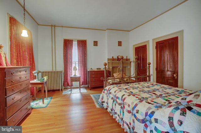 144 W Main St, Waynesboro, PA 17268 - bedroom featuring ornamental molding, radiator heating unit, and light wood-style flooring