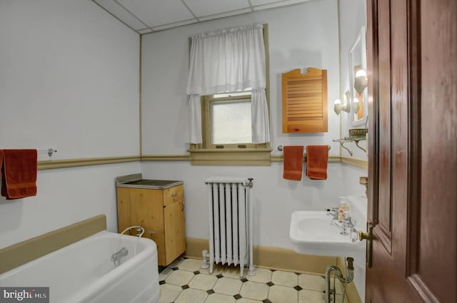 144 W Main St, Waynesboro, PA 17268 - bathroom featuring radiator heating unit, a tub, tile patterned floors, a sink, and a paneled ceiling