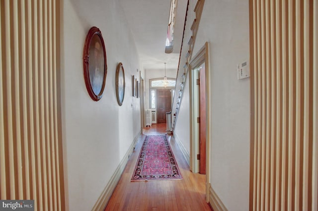 144 W Main St, Waynesboro, PA 17268 - corridor with wood finished floors, baseboards, stairs, radiator heating unit, and wallpapered walls