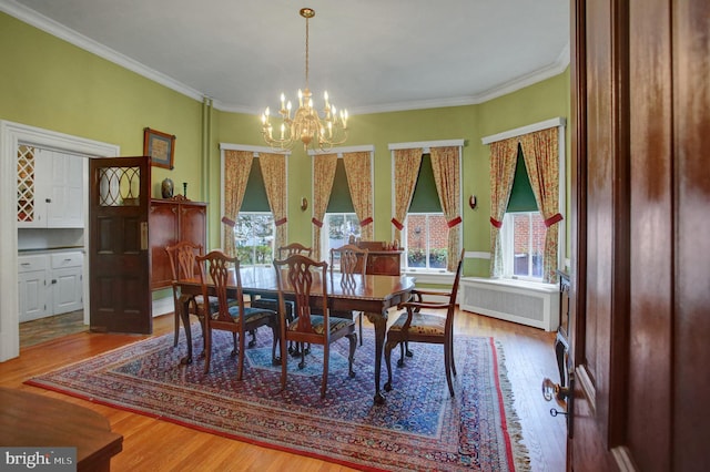 144 W Main St, Waynesboro, PA 17268 - dining room featuring a chandelier, wood finished floors, crown molding, and radiator heating unit