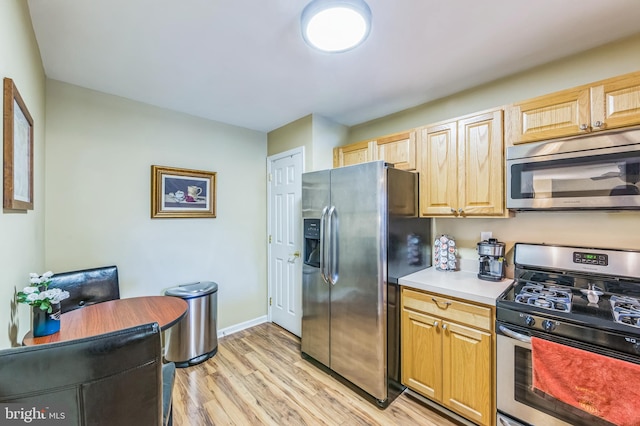 kitchen featuring light hardwood / wood-style flooring, stainless steel appliances, and light brown cabinets