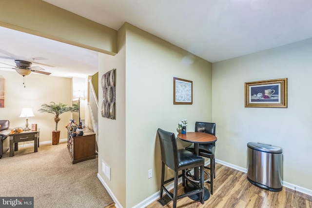 dining area featuring ceiling fan and wood-type flooring