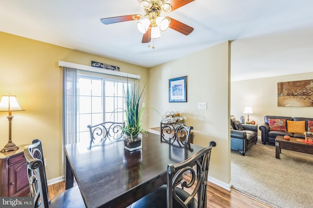 dining space with ceiling fan and hardwood / wood-style floors