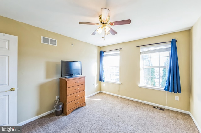 bedroom featuring ceiling fan and light carpet