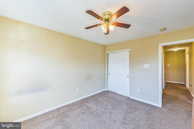 unfurnished bedroom featuring light carpet, a closet, and ceiling fan