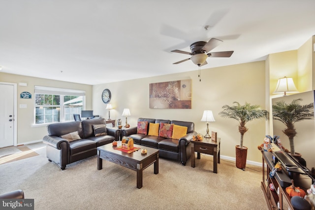 carpeted living room with ceiling fan