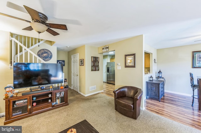 living room featuring ceiling fan and wood-type flooring