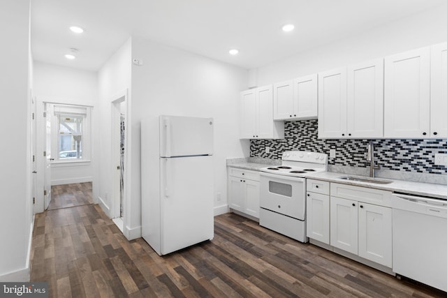 kitchen with dark wood-type flooring, white appliances, white cabinets, and sink