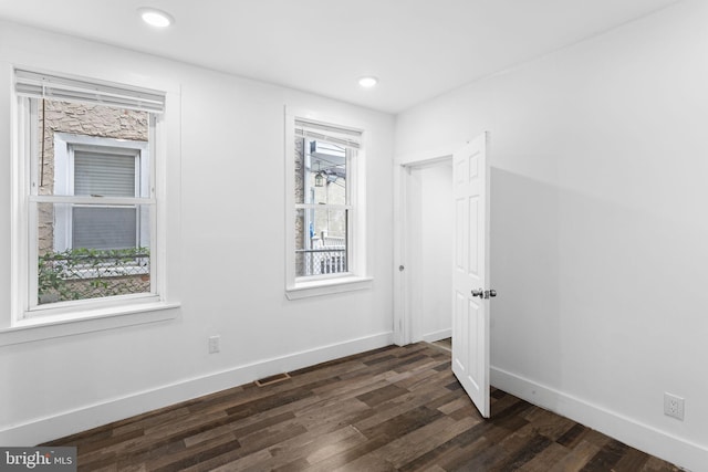 unfurnished room with dark hardwood / wood-style floors