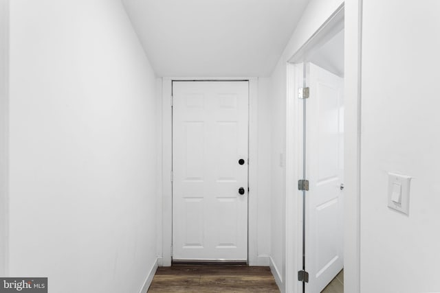 corridor featuring dark hardwood / wood-style flooring