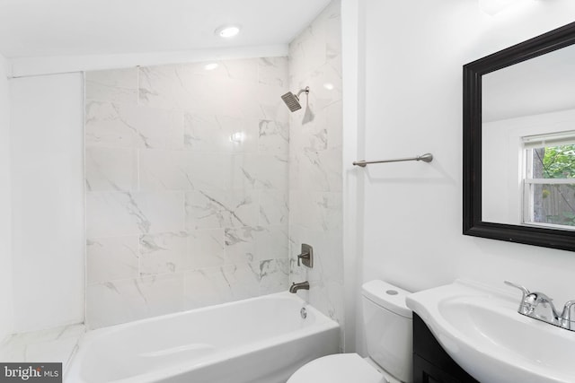 full bathroom featuring tiled shower / bath, toilet, and vanity