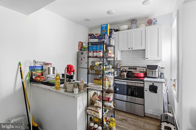 kitchen featuring electric stove, white refrigerator, decorative backsplash, white cabinets, and dark wood-type flooring