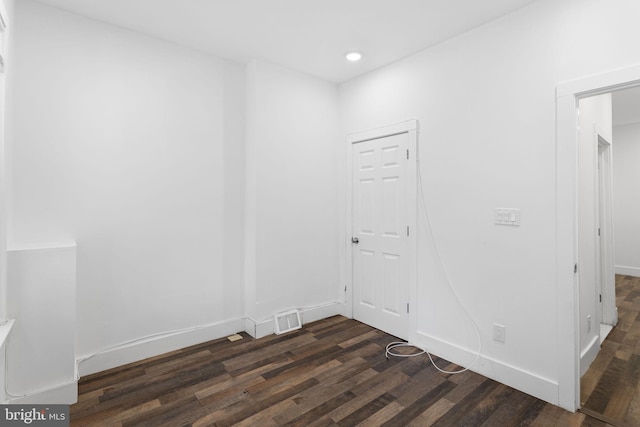 empty room featuring dark hardwood / wood-style flooring