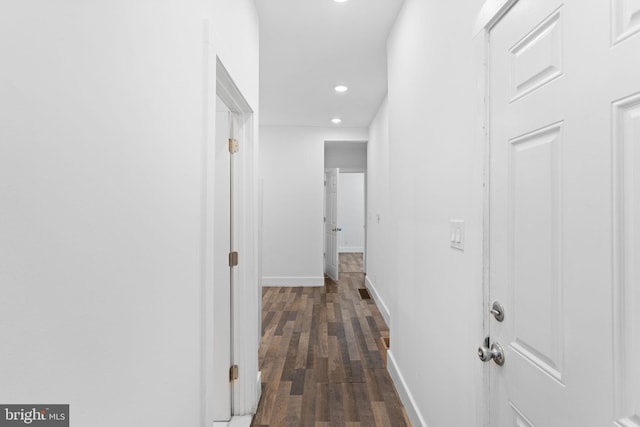 hall with dark wood-type flooring