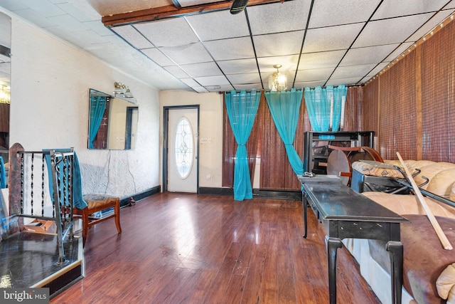 interior space featuring dark wood-type flooring and a paneled ceiling