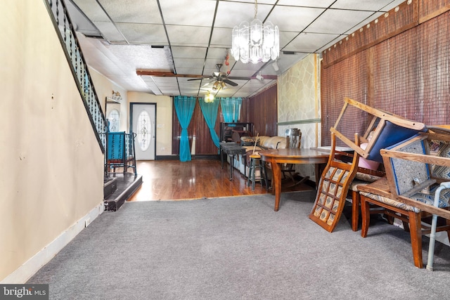 interior space featuring a drop ceiling, wood-type flooring, and ceiling fan