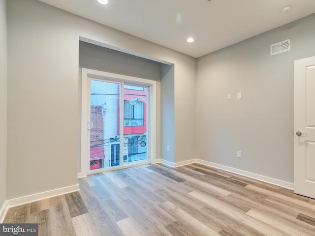 empty room with light hardwood / wood-style floors