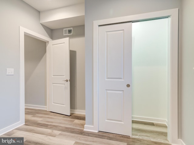 hall with light hardwood / wood-style flooring