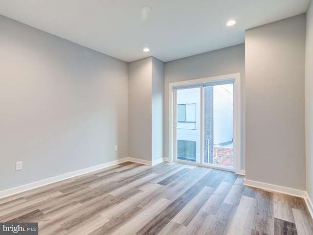 unfurnished room with light wood-type flooring