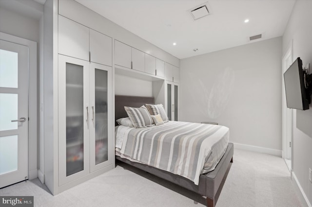 bedroom with light colored carpet