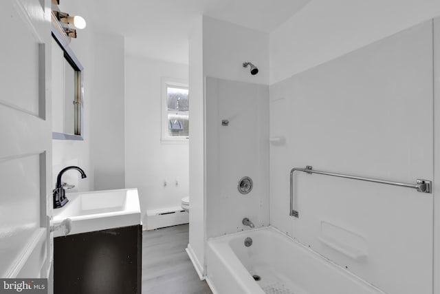 full bathroom featuring shower / bathtub combination, vanity, a baseboard radiator, hardwood / wood-style floors, and toilet