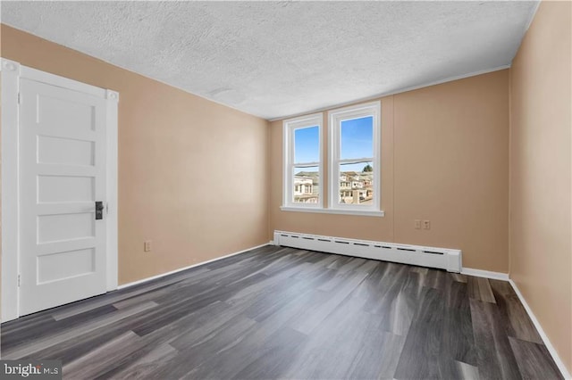 spare room with a textured ceiling, a baseboard radiator, and dark hardwood / wood-style floors