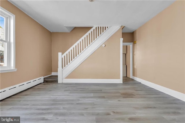 interior space with hardwood / wood-style flooring and a baseboard radiator