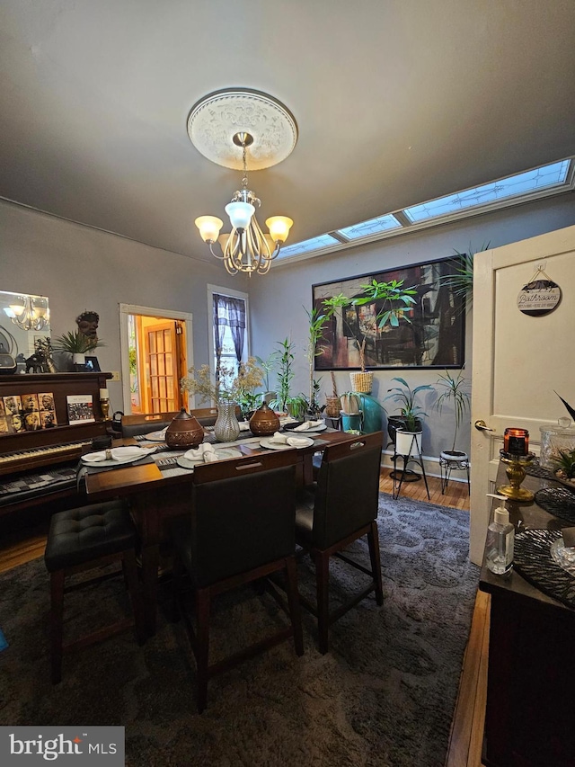 dining area featuring a chandelier and wood-type flooring