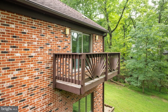 wooden terrace featuring a yard