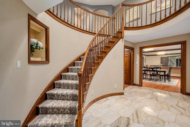 stairway featuring a high ceiling