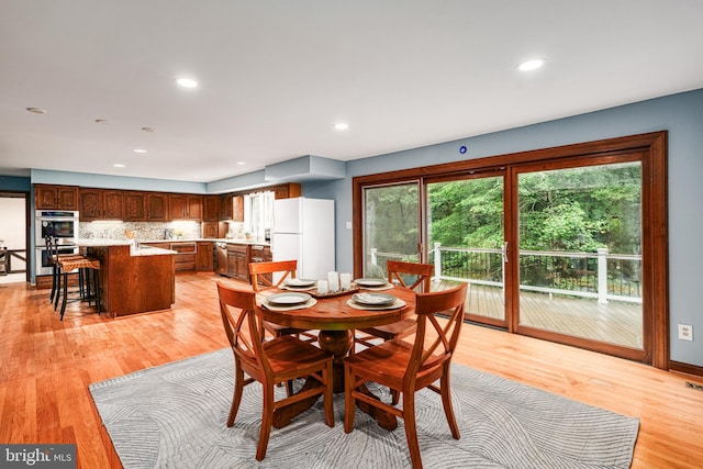 dining space with light hardwood / wood-style flooring