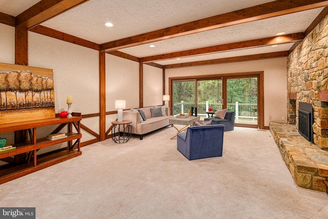 carpeted living room featuring a fireplace, a textured ceiling, and beam ceiling