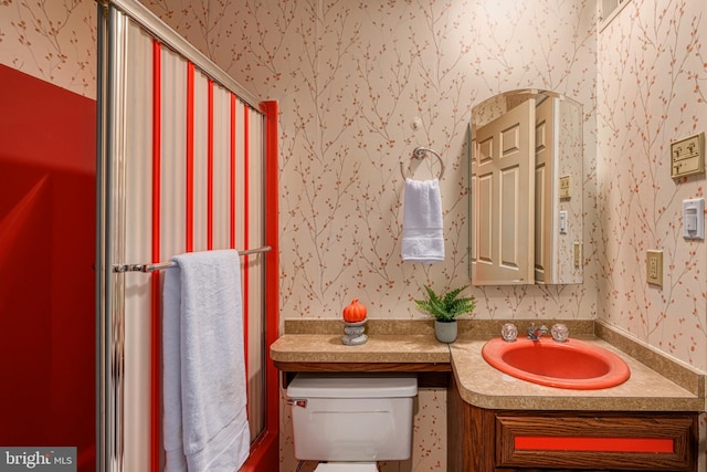 bathroom featuring toilet and vanity