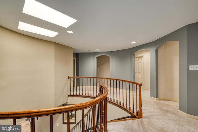 hall featuring light colored carpet