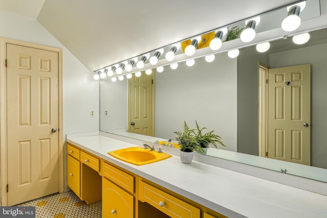 bathroom with vanity and lofted ceiling