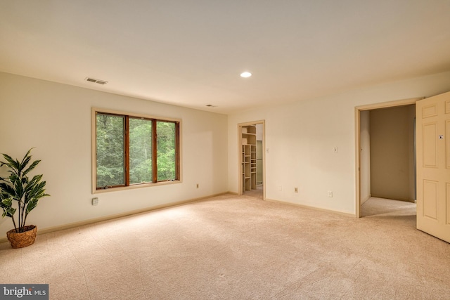 unfurnished room featuring light colored carpet