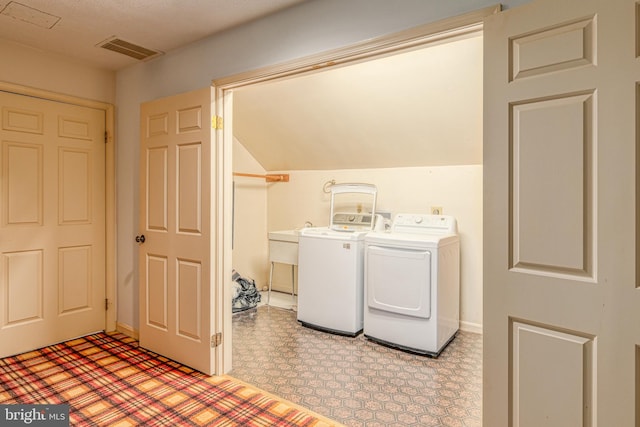 clothes washing area with washing machine and dryer